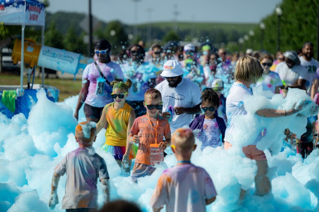 Kids and adults in a foam party