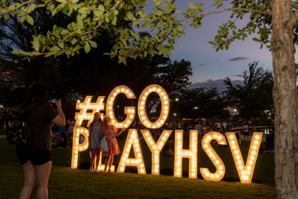Kids posing with large GO PLAYHSV letters